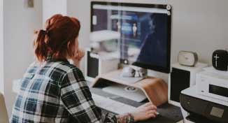 Imagen de  Lady sitting in home office working on her computer.